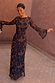 Model wearing the Mesh Dress in Tan Jaden Floral Print with long flared sleeves.