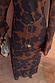 Close up of the Mesh Dress in Tan Jaden Floral Print with a gold sun and eye charm belt.