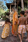 Girl's yellow cotton sun dress featuring a sun print and shirred top, part of a matching family vacation look.