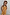 Thumbnail for Girl wearing a yellow cotton maxi sun dress with a sun print and shirred bodice against a wooden wall.
