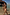 Thumbnail for Boy's Yellow Sun Swim Shorts with a soleil print, worn by two boys walking in shallow beach water.