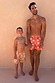 Boy's Yellow Sun Swim Shorts with a white soleil print, worn by a young boy for a sunny family vacation look.