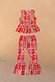 Girl's pink fruit print two-piece set featuring a sleeveless peplum top and matching flared trousers.