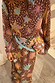 Bandana Star Fawn marrone con stelle e cuori annodata in vita su un abito coordinato per un look multi-wear.