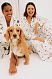 models are wearing white tattoo pyjamas and sitting with a dog