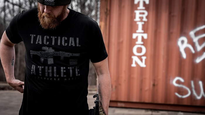 A veteran in a black t-shirt from Combat Iron that says 