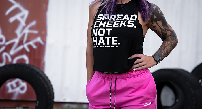 A lady with tattoos wearing Combat Iron Apparel brand clothing.