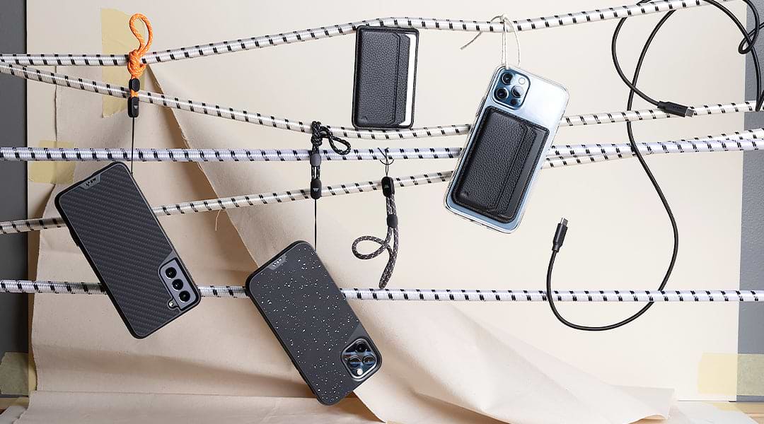 Mous products hanging from cables including phone wallets, protective cases and phone cables