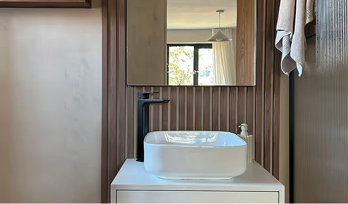 Irregular wall mirror in a bathroom setting