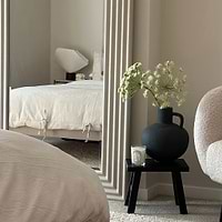 Full length ribbed concrete mirror leaning against wall