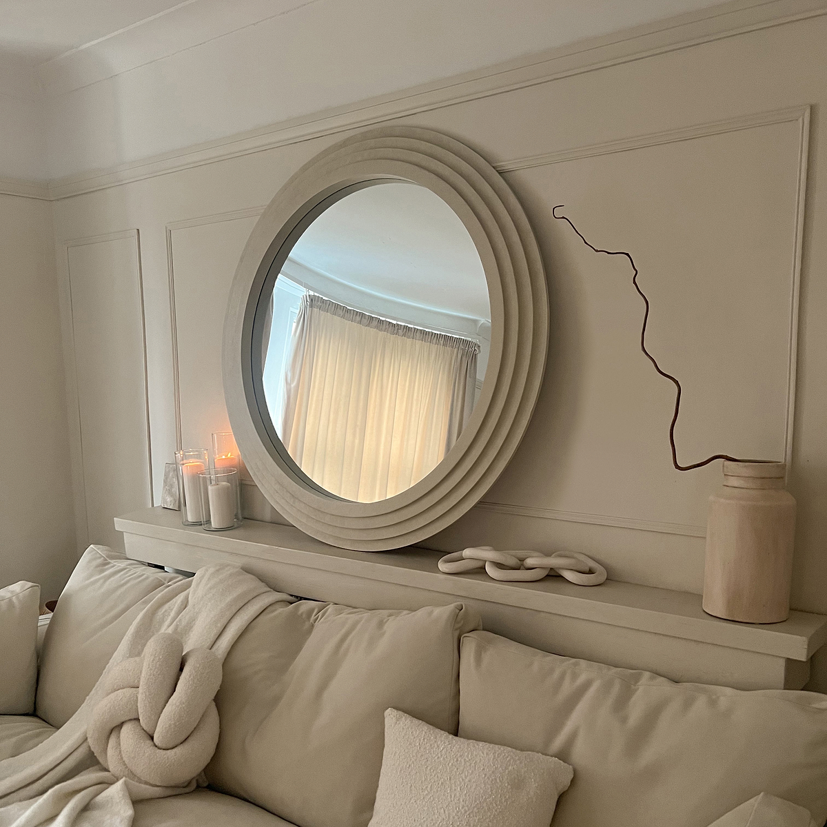 Round Concrete Wall Mirror above bed