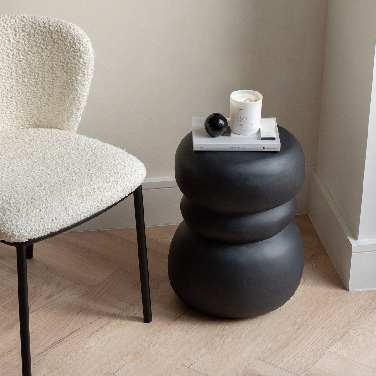 Minimal Onyx Side Table decorated with books and candle