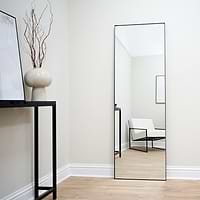 Full Length Black Rectangular Large Metal Mirror reflecting lounge chair
