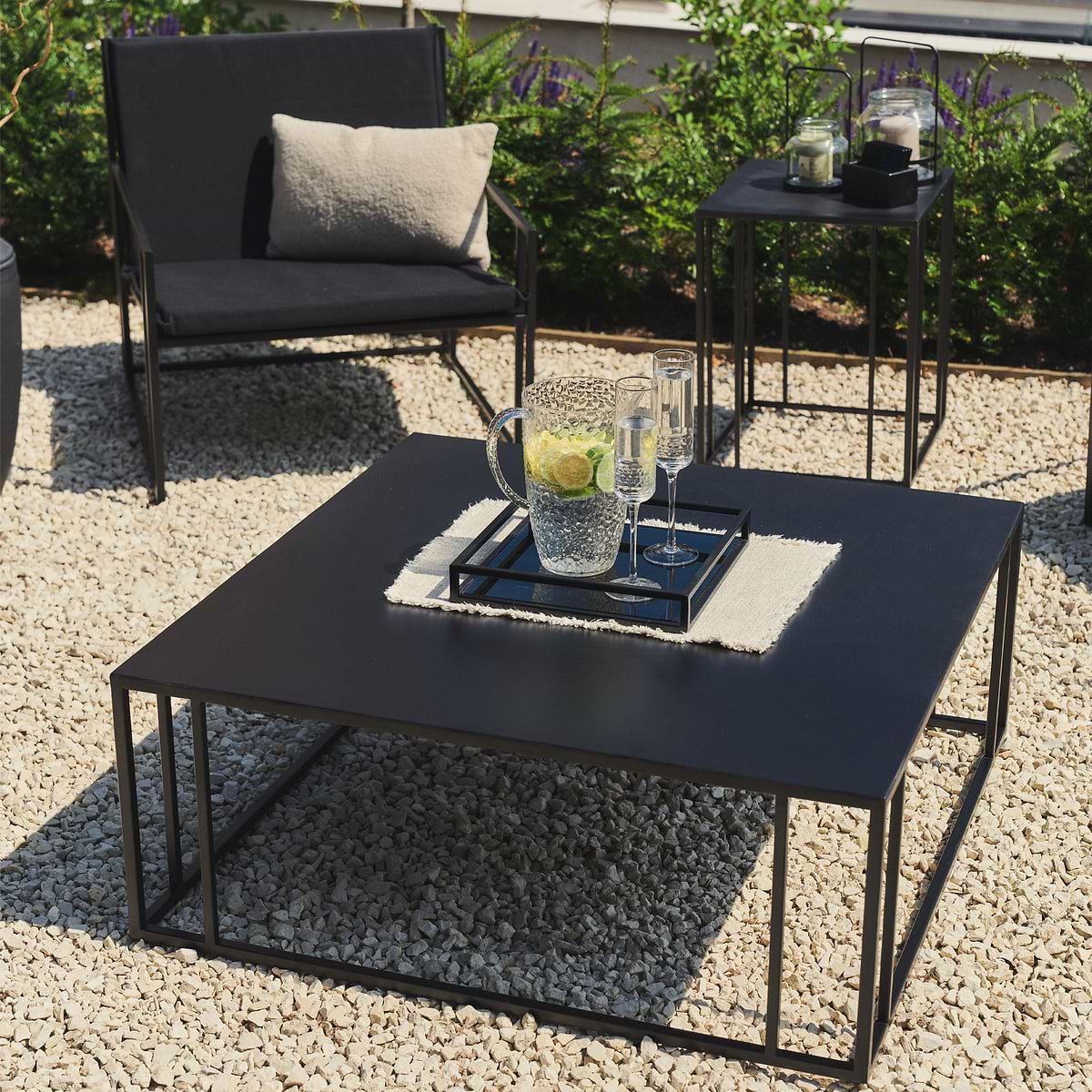 Rectangular Black Modern Garden Coffee Table with jug holding citrus drink