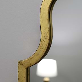 Closeup Gold industrial arched full length metal mirror