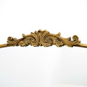 Closeup of Gold arched ornate metal overmantle mirror