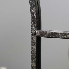 Crushed black industrial arched full length metal mirror detail shot of side
