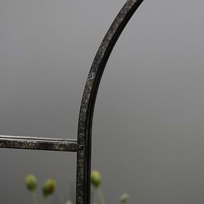 Crushed black industrial arched full length metal mirror detail shot of arch