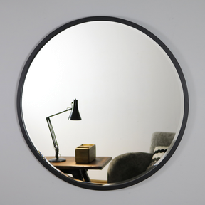 Black Metal Modern Round Wall Mirror on living room wall