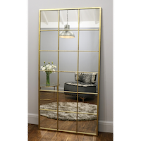 Full length large gold industrial metal window mirror leaning against wall