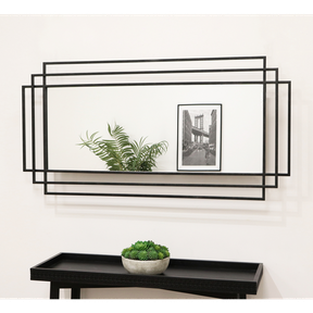 Large black rectangular metal mirror displayed on wall