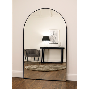Black Full Length Arched Metal Mirror reflecting lounge