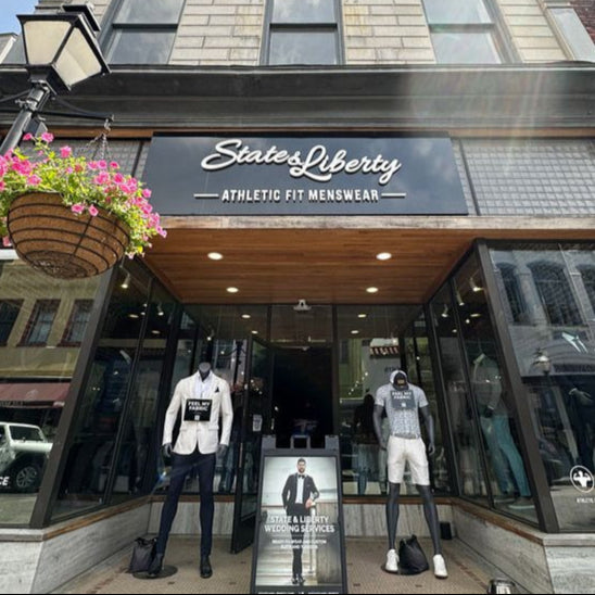 Storefront of States of Liberty athletic fit men's wear with mannequins and promotional poster.