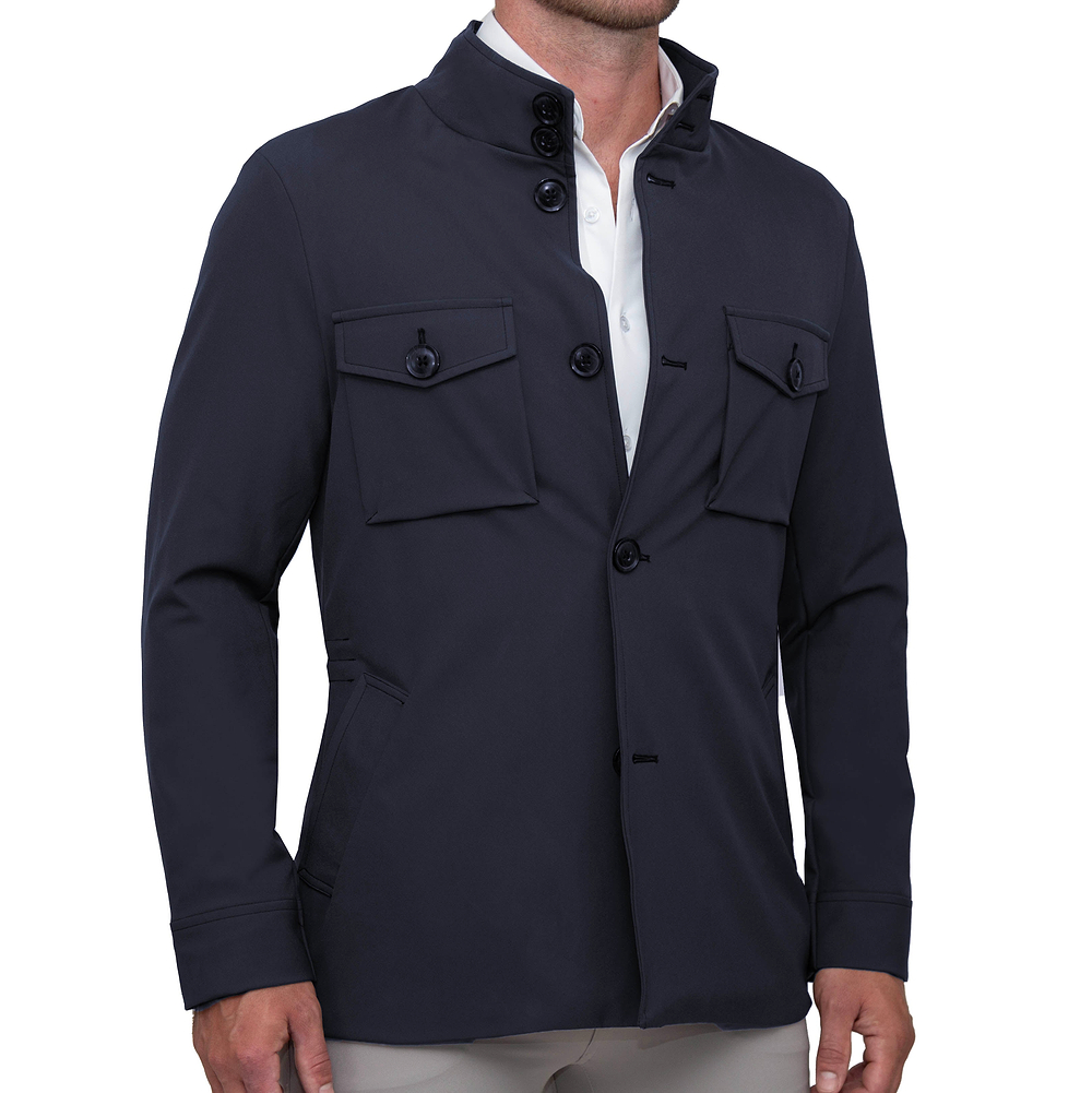 A navy field jacket with a high collar, patch pockets, and button closures. The jacket is modeled by a person facing to the side, showcasing the fit and design.