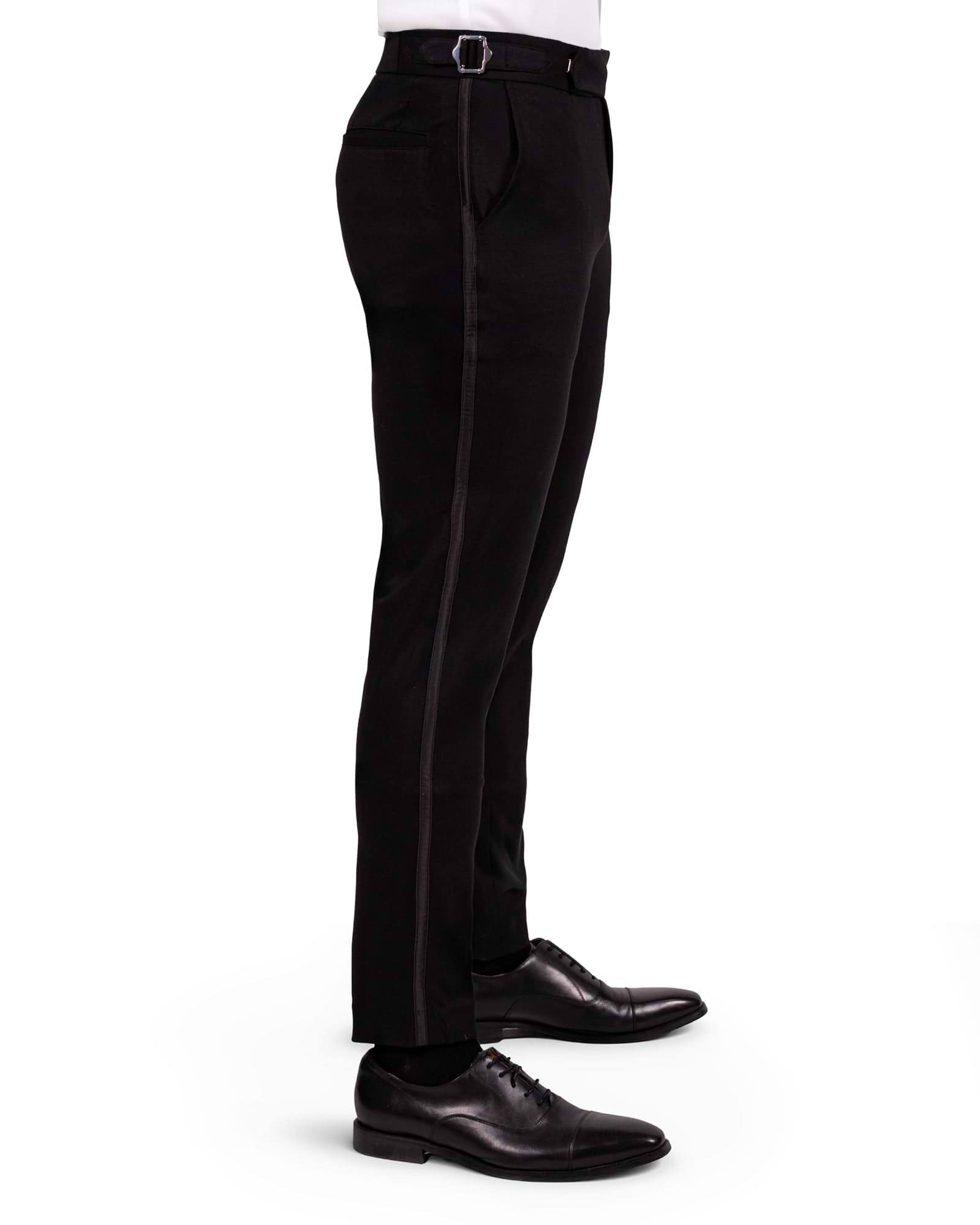 Black dress pants worn by a person on a white background