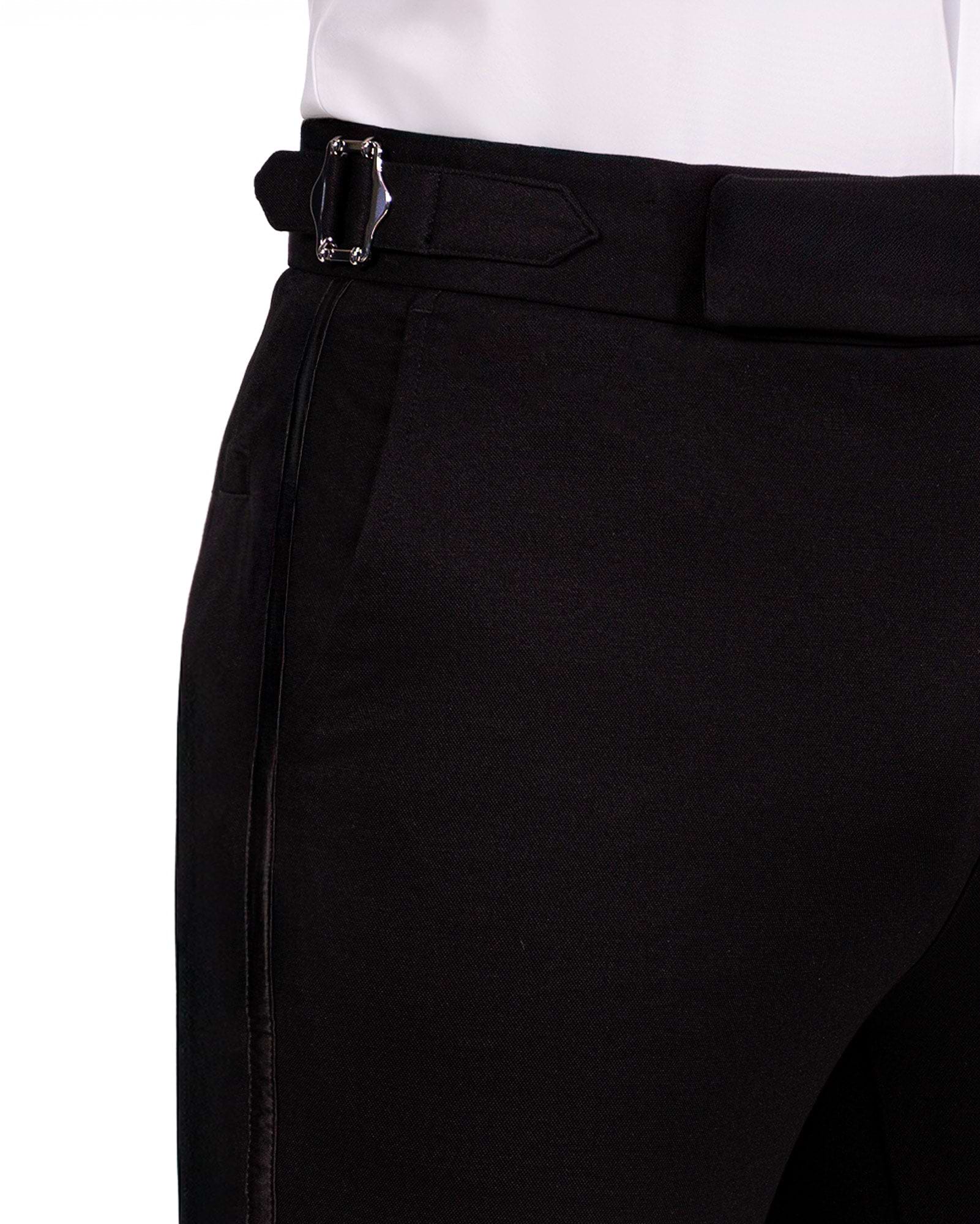 Close-up of black pants with a belt on a white background