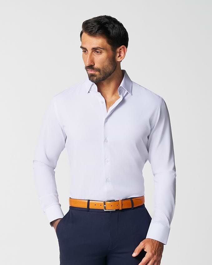 Man wearing a white dress shirt, navy pants, and brown shoes on a white background