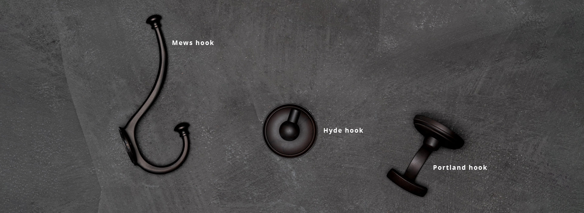 Assortment of 3 solid brass hook varieties, set against a dark and grainy background