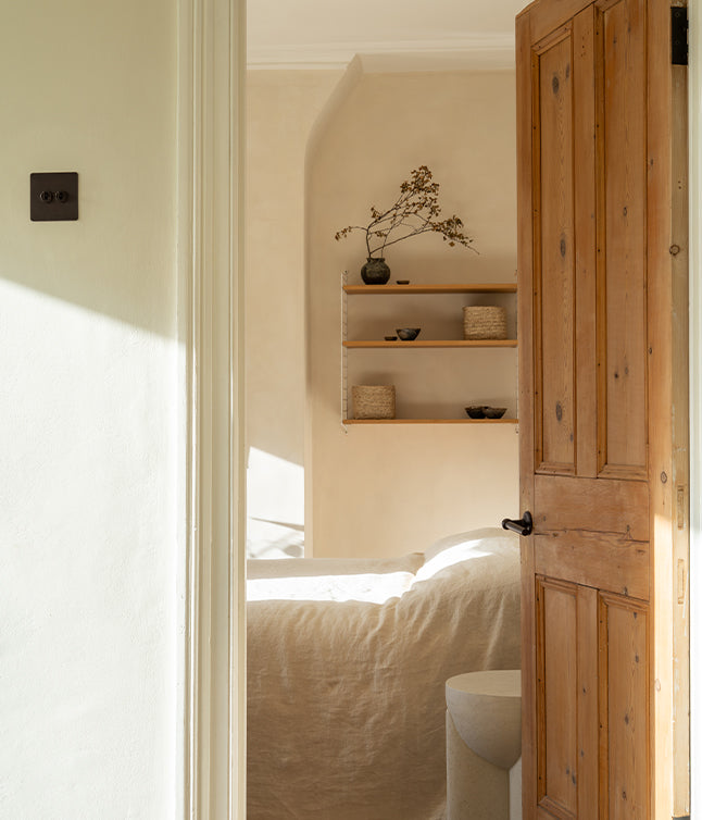 Contemporary living space with wooden features and bronze light switches