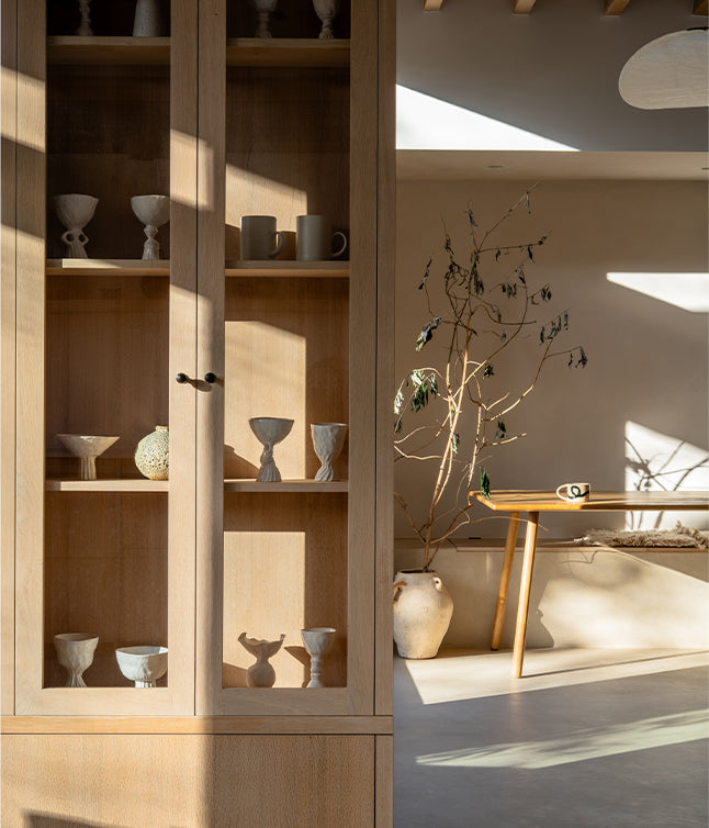 Kitchen storage cupboard with glass panes, revealing the contents inside