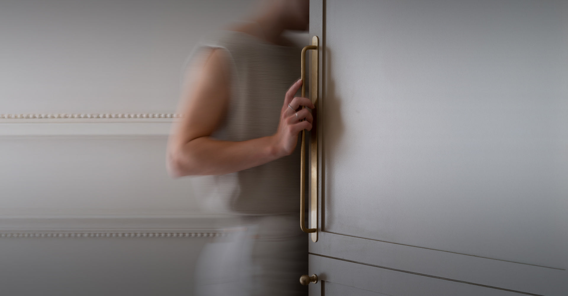 A dark bronze EU socket on a marble wall