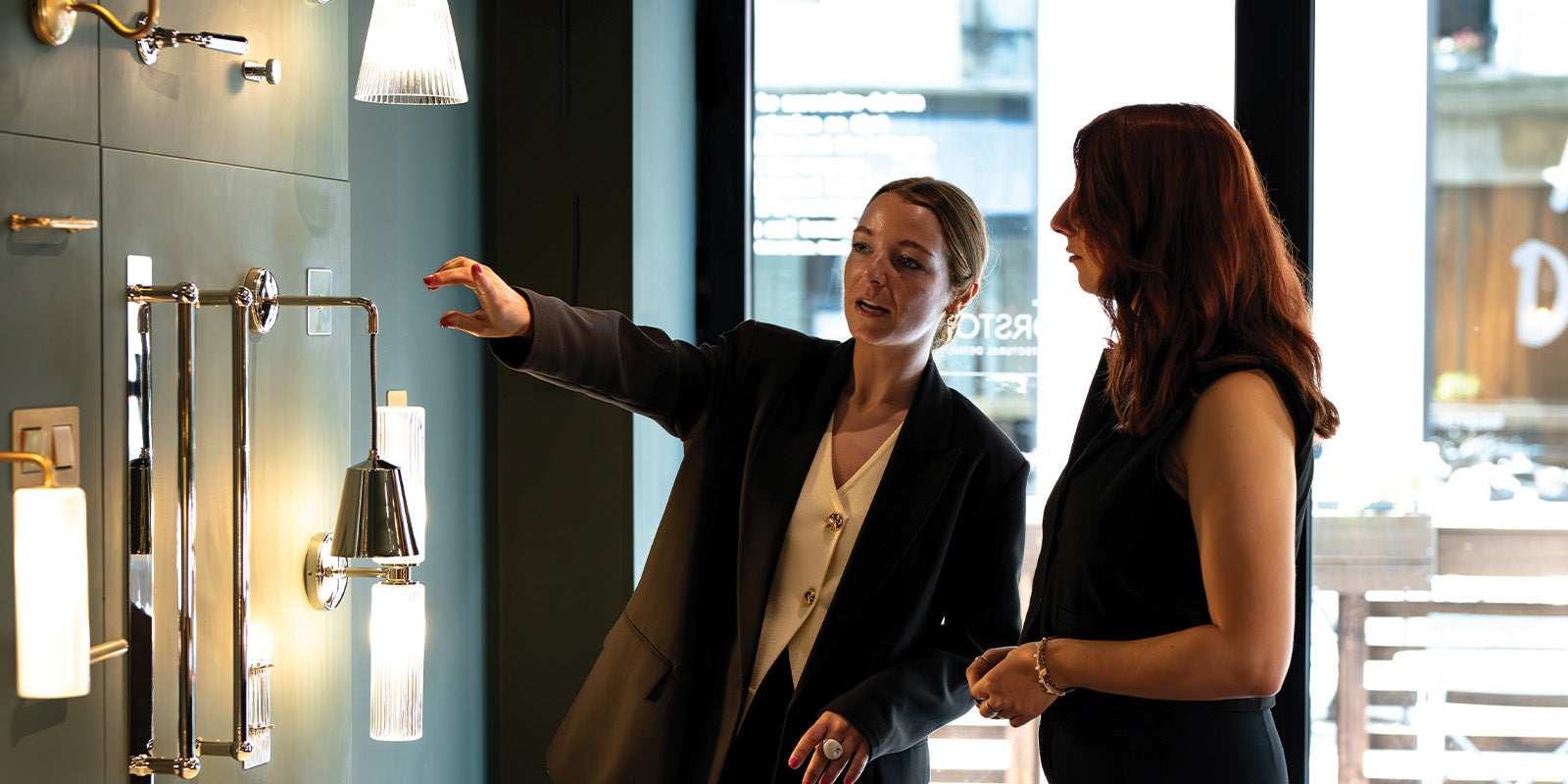 Flagship store staff member explaining displayed products to a customer.