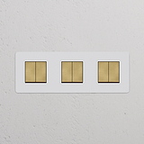 Dreifachrahmen mit 6x Wippschalter in antikem Messing und Weiß, lackierbar für vielseitigen Einsatz.