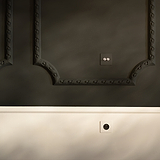 2x Wissel-Tuimelschakelaar met Enkele Afdekplaat in beschilderbaar gepolijste nikkelafwerking op een donkere muur.