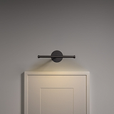 Taylor schilderijverlichting 220mm in brons, ideaal voor het verlichten van kunstwerken op een grijze muur boven een deur.