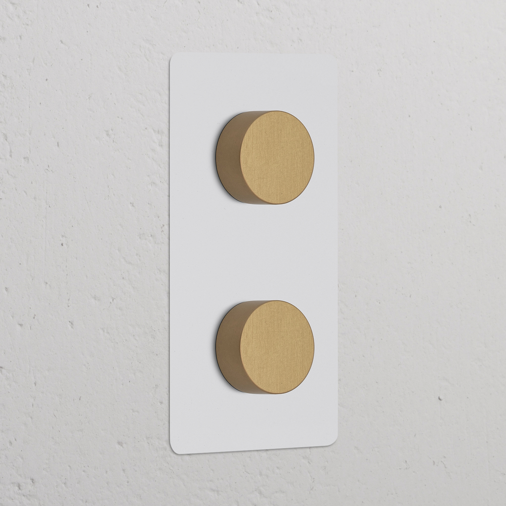 2x Dimmer met dubbele verticale schakelaars in Beschilderbaar Antiek Messing afwerking op een witte rechthoekige basis.