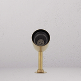 Ealing Grond Spotlight met antieke messing afwerking, die buitenruimtes verfraait met zijn warme gloed.