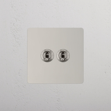 Dual Control Light Toggle Switch on White Background: Polished Nickel Single 2x Toggle Switch