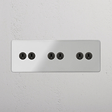 Functional Six-Position Triple Toggle Switch in Clear Bronze for Light Switching on White Background