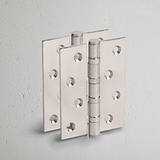 Polished Nickel Curtis Door Hinge Pair on White Background