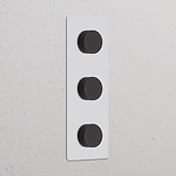 Vertikaler Dreifachrahmen mit 3x Dimmerschalter in lackierbarem + bronzenem Design.