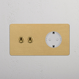 Doppelrahmen in Antikmessing und Weiß mit zwei Knebeln und einem Schuko-Modul für elegante, moderne Funktionalität.