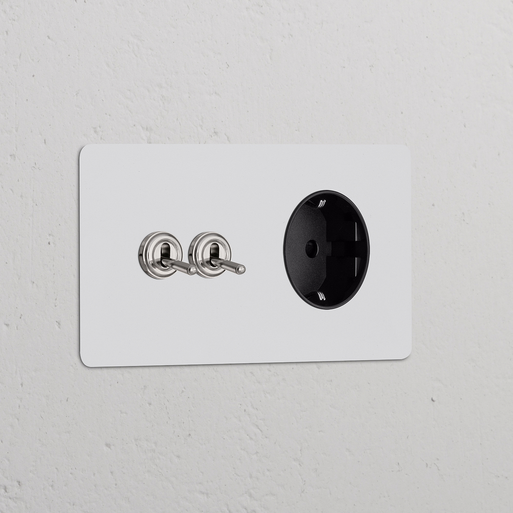 Zweifachrahmen mit 2 Kipphebelschaltern + Schuko Typ F Steckdose, lackierbar, poliertes Nickel + Schwarz.