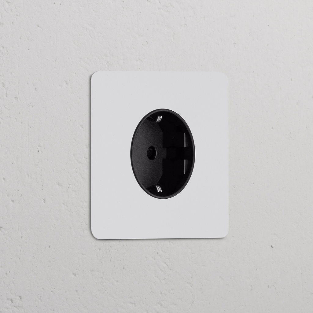 Módulo Schuko tipo F redondo (marco simple), pintable con inserto negro, para tomas eléctricas.