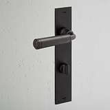 Manilla para puertas Digby con placa larga (con muelle) y sistema giratorio - Bronce