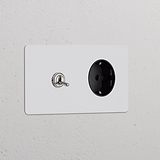 Marco doble de pared con interruptor de palanca y base Schuko tipo F; pintable, acabado níquel, inserto negro.
